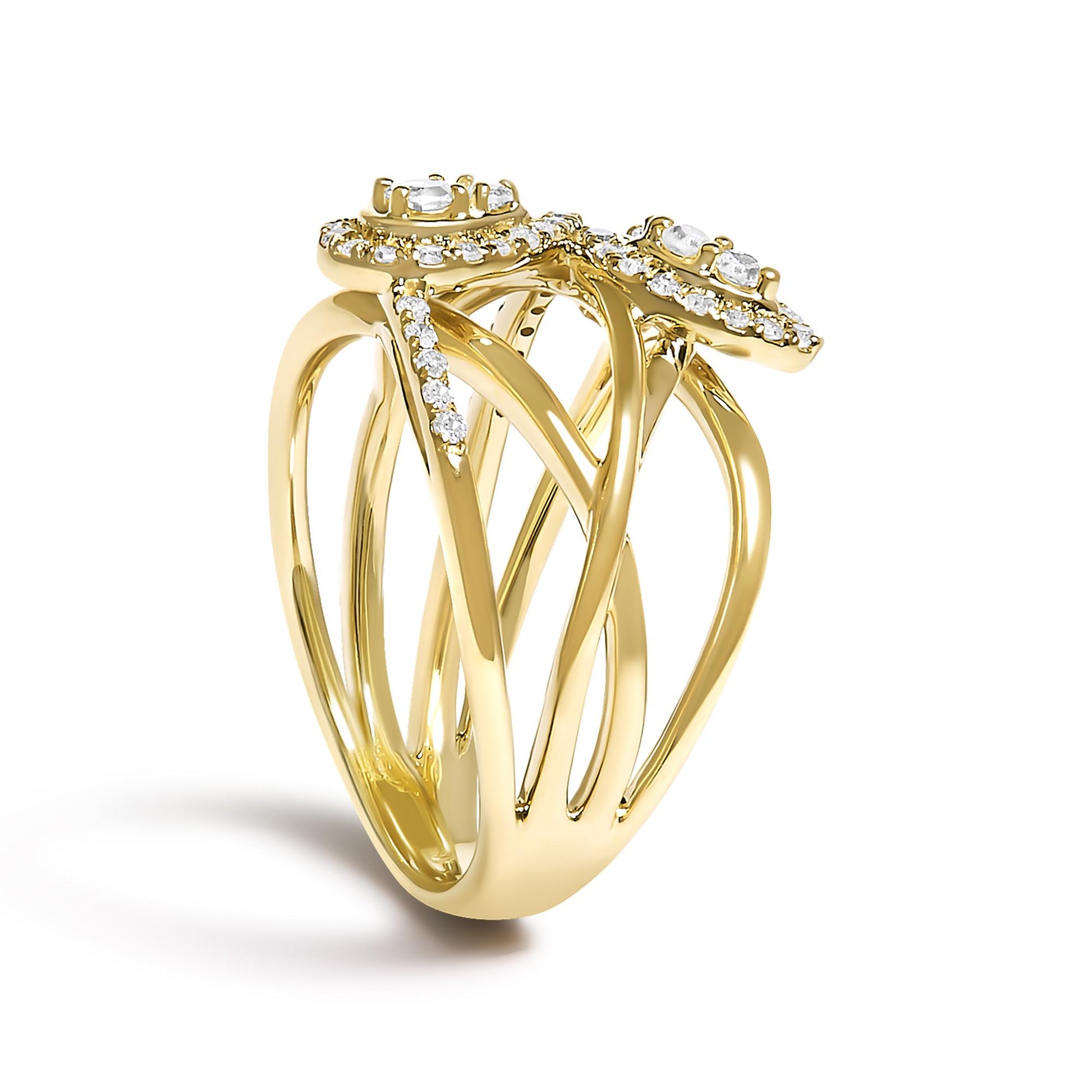 Yellow metal ring with intertwined bands and round white gemstones in prong settings, shown at a slight angle against a white background.