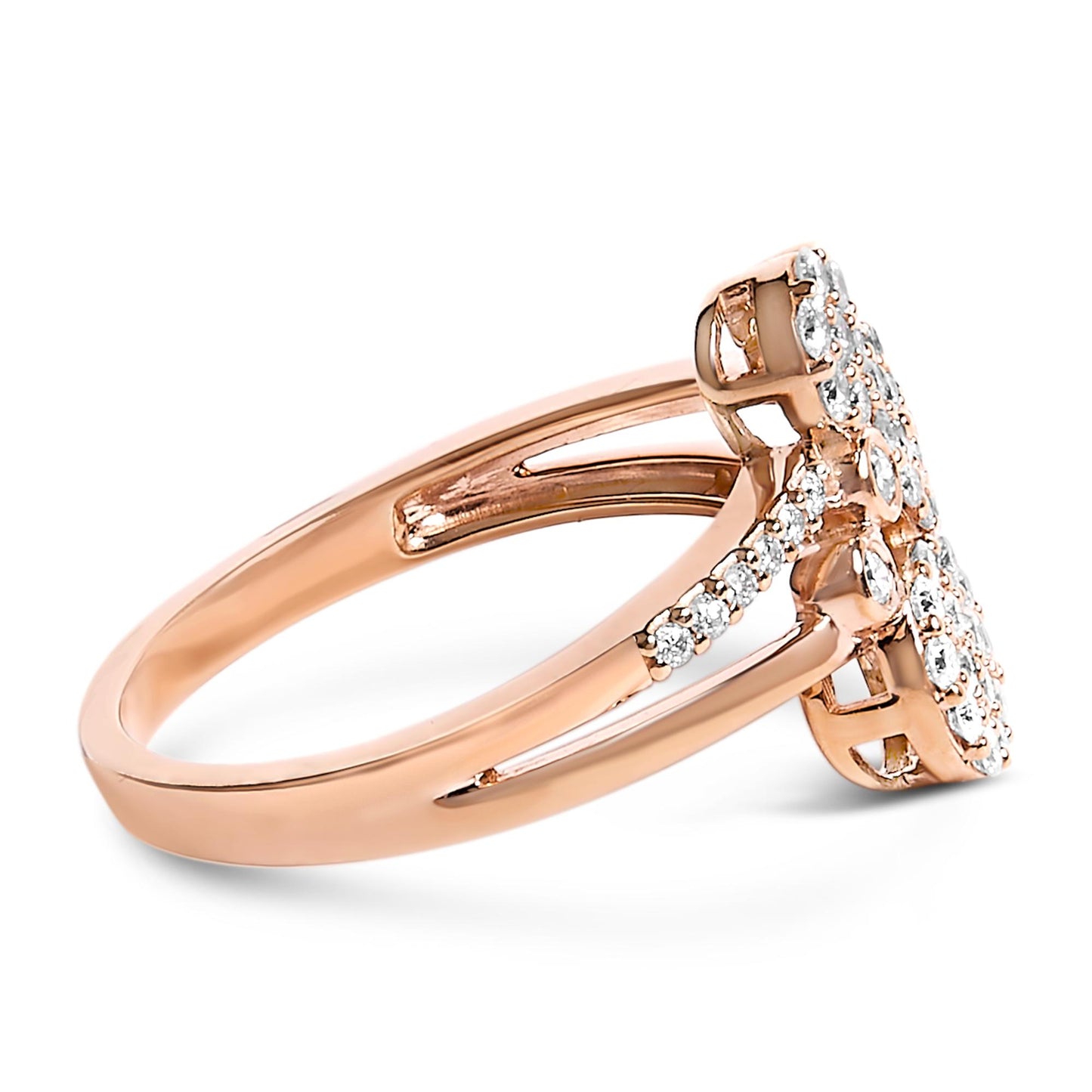 Side angle of a rose-colored metal ring featuring multiple round white gemstones in prong settings arranged on the split shank and top cluster.