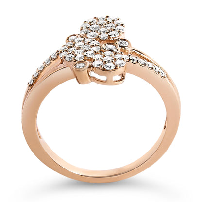 Close-up front angle of a rose-colored ring with multiple clusters of round white gemstones in prong settings on the top and along the band.