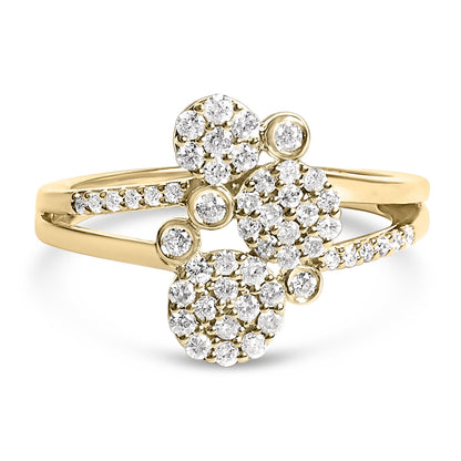 Close-up front angle of a yellow ring featuring multiple clusters of round white gemstones in prong settings along the band and top.
