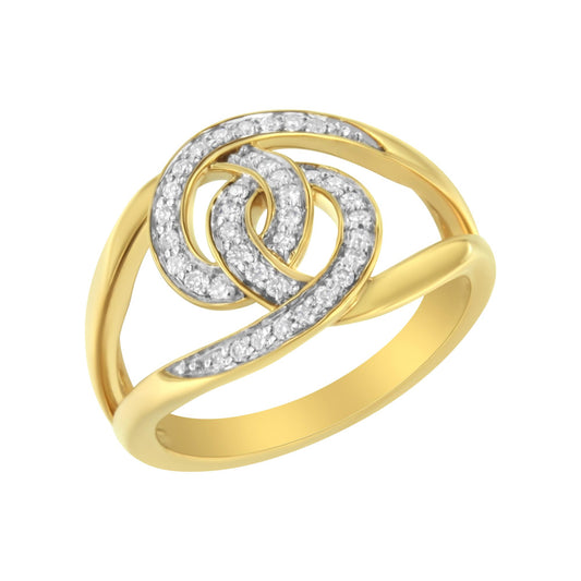 Yellow metal ring with intertwined design adorned with round white gemstones in pave setting, viewed from a slightly angled top perspective.