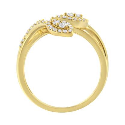 Yellow metal ring with round white gemstones in prong settings, shown from a side angle.