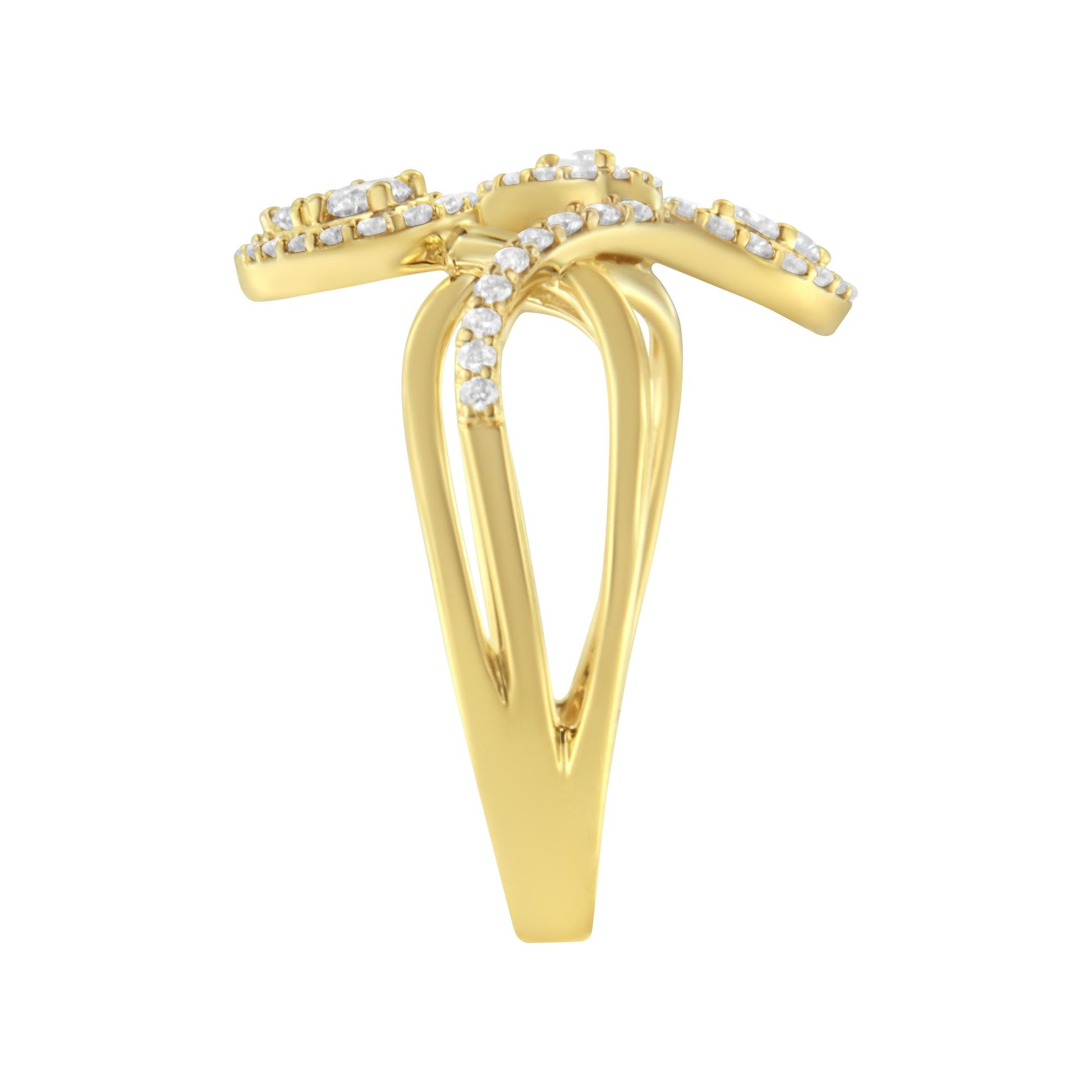 Yellow metal ring with a split shank design, featuring a crossover top adorned with small white gemstones, shown from the front angle.