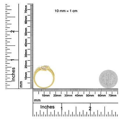 Yellow metal ring with multiple round white gemstones in prong settings, shown in a side profile angle, placed on a ruler for size reference.