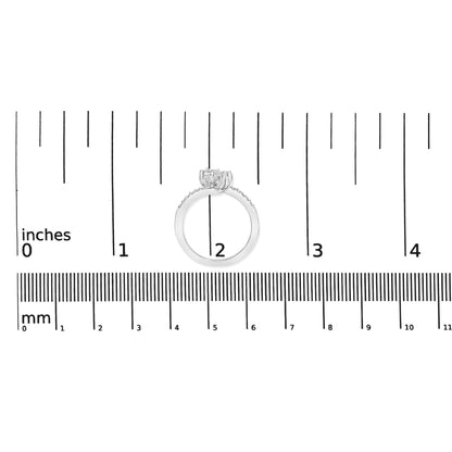 White metal ring with a round center gemstone in miracle setting flanked by two round gemstones, with additional smaller round gemstones along the band in shared prong setting, shown on a scale from a side angle.