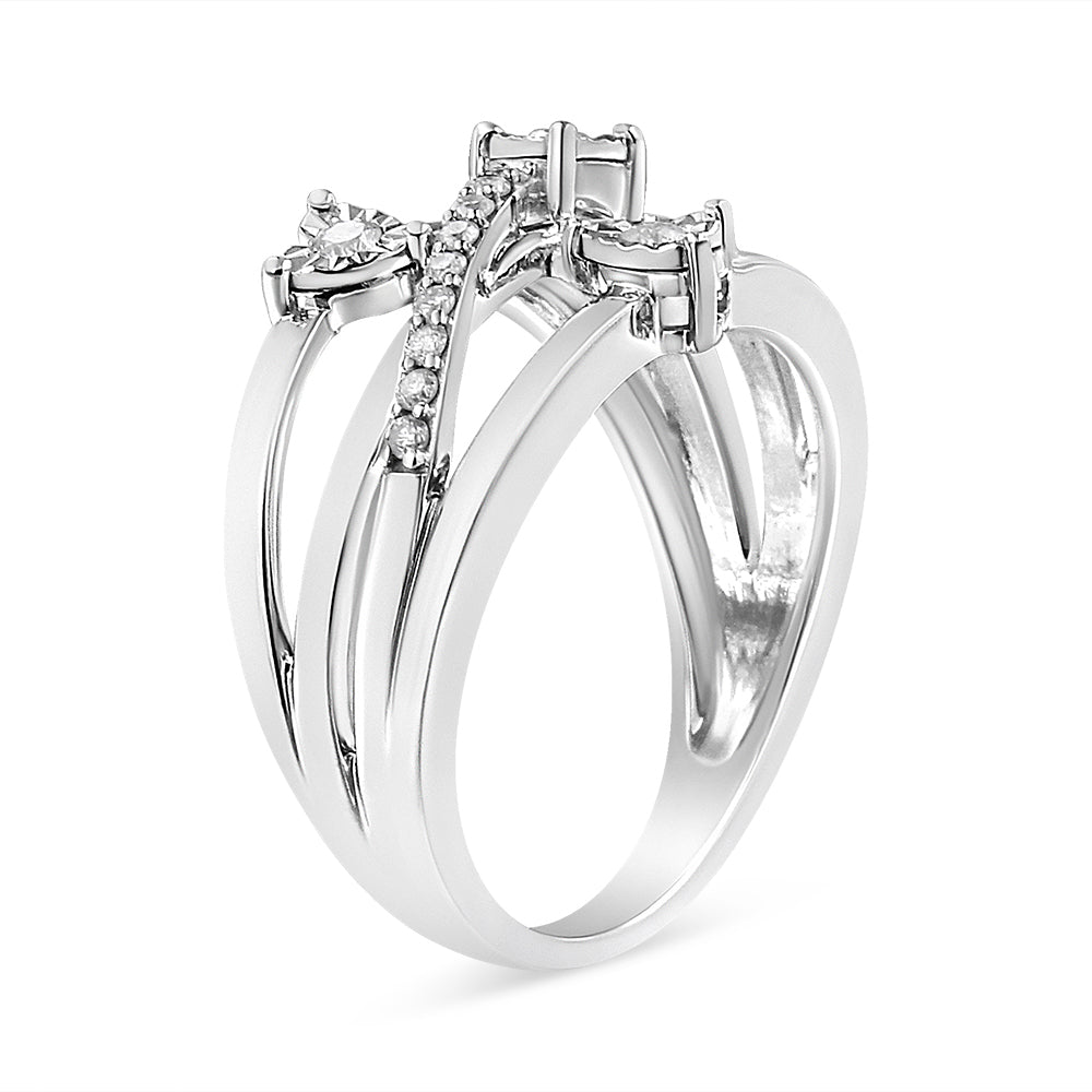 White metal ring with three bands joined together, featuring round white gemstones in prong and miracle settings, shown from a front-side angle.