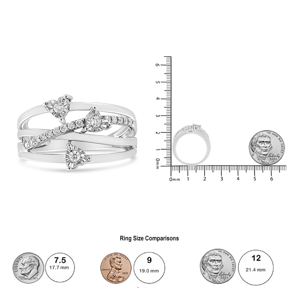 White ring with three round white gemstones in miracle setting and multiple smaller round white gemstones in prong setting, shown from an angled top-front view, with a ruler and coin for size reference.