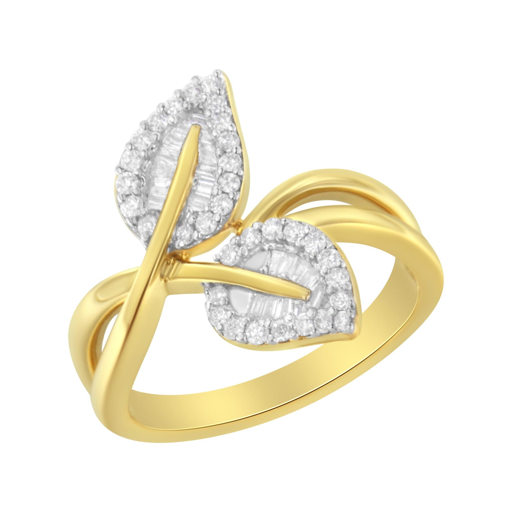 Yellow metal ring with an open design featuring two leaf shapes adorned with white round prong-set gemstones around the edges and white baguette channel-set gemstones in the center, shown in a close-up angled view.