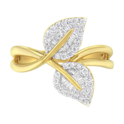Top-front angle of a yellow ring featuring two leaf-shaped sections adorned with round prong-set white gemstones around the edges and baguette channel-set white gemstones in the centers.