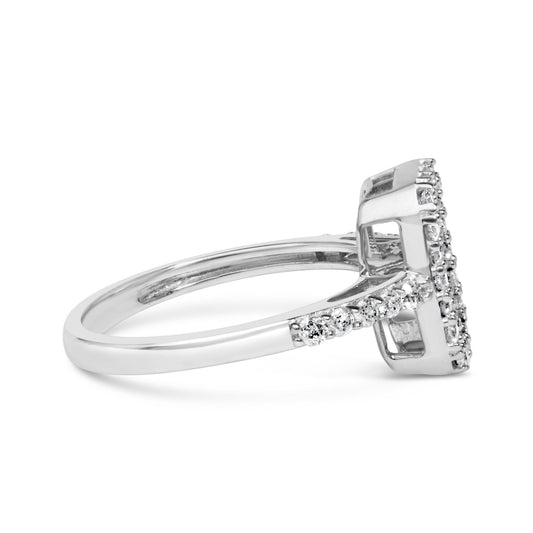 Side view of a white ring featuring a raised rectangular setting with white round gemstones in prong settings along the band and cluster on the top.