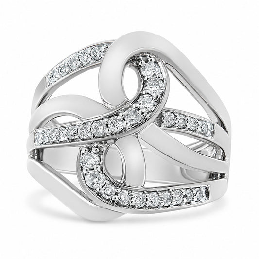 Close-up angled view of a white metal ring featuring an abstract, looping design with multiple round white gemstones set in prong settings along curved bands.