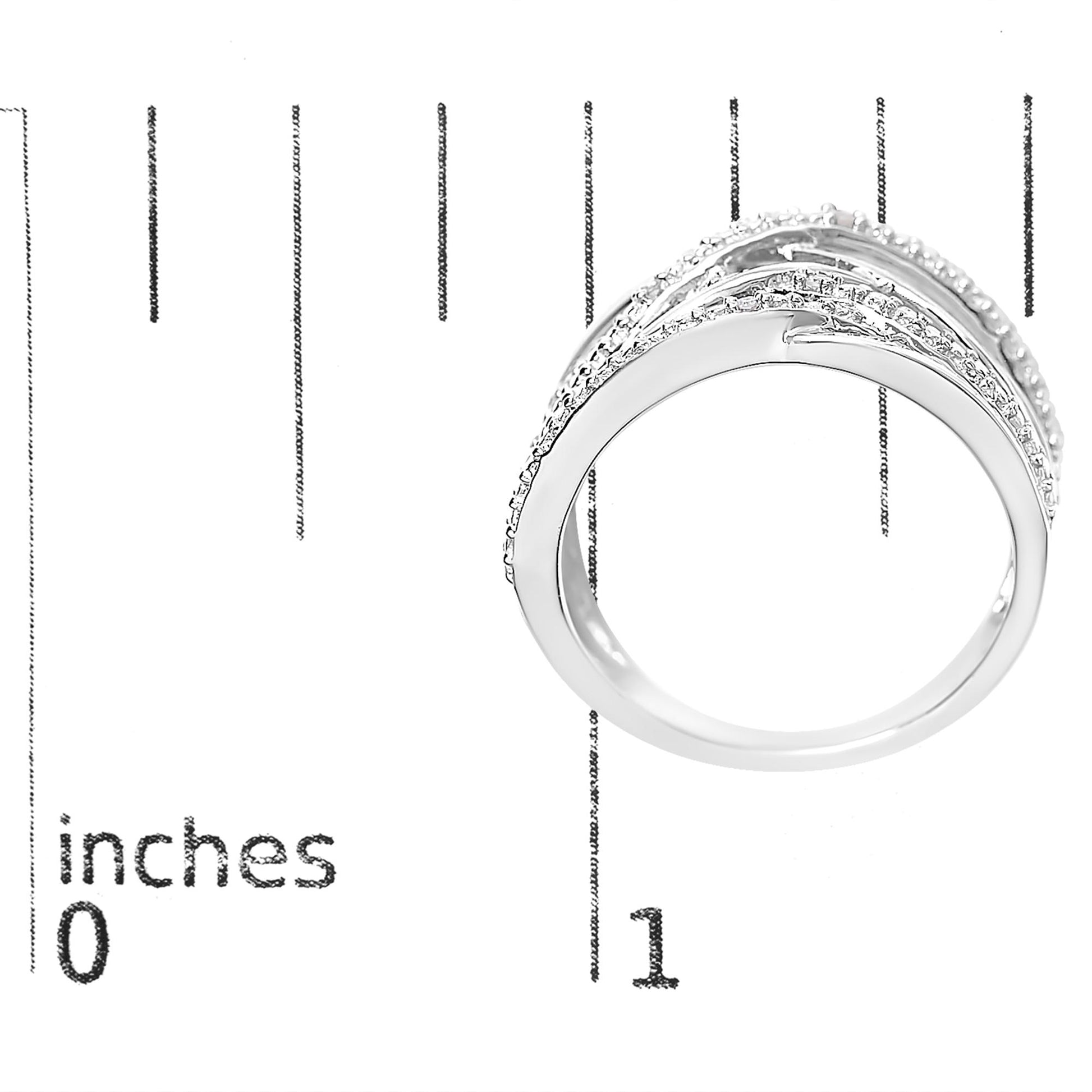 White metal ring with curved bands and pave set round white gemstones, shown on a ruler for size reference, side view.