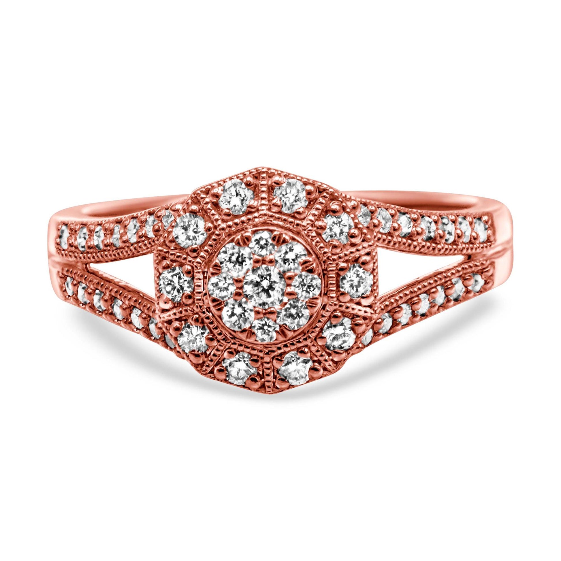 Close-up front view of a rose-colored ring with a hexagonal cluster of white round gemstones in pave setting, featuring additional white round gemstones along the split shank.