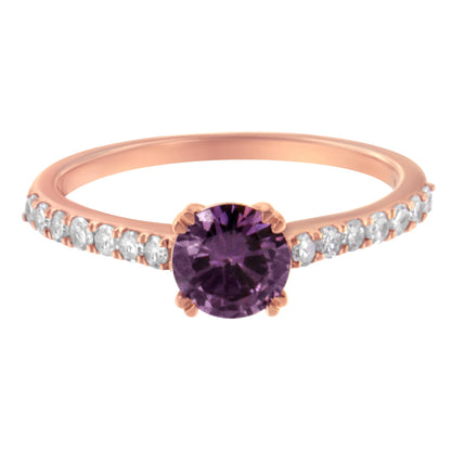 Front angle view of a rose-colored ring with a round purple gemstone in the center and small white gemstones lined along the band.