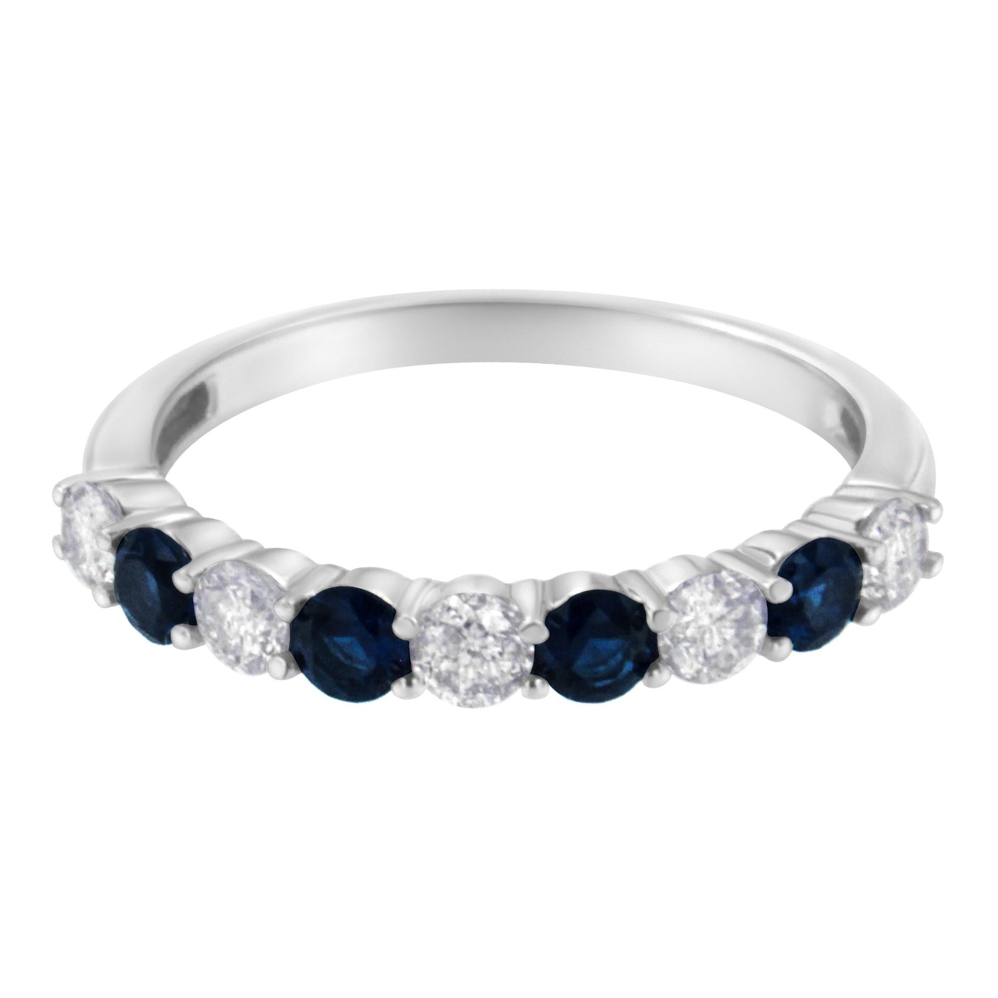 White metal ring with alternating round white gemstones and blue gemstones in prong settings, shown in a close-up front angle.