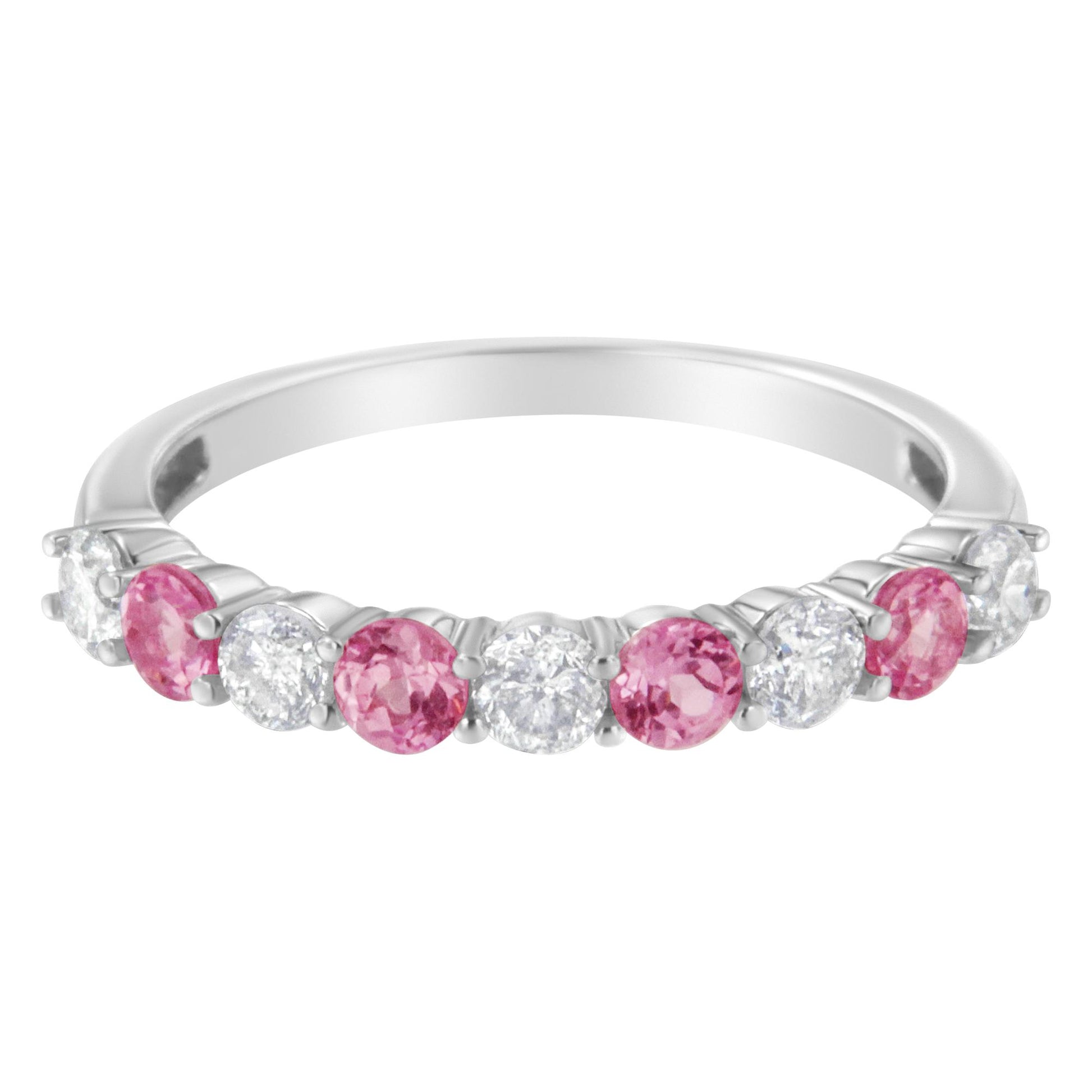 Front angled view of a white metal ring featuring alternating round white gemstones and round pink gemstones in prong settings.