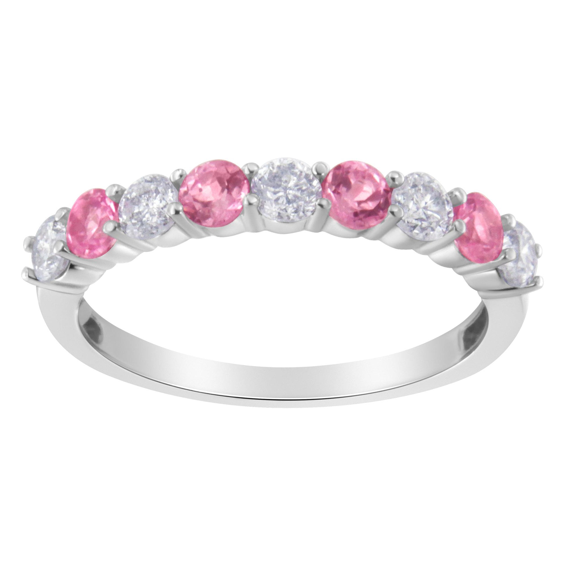 White metal ring with alternating round white and pink gemstones in prong settings, shown from a side angle.