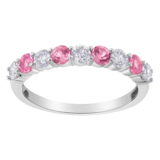 White metal ring with alternating round white and pink gemstones in prong settings, shown from a side angle.
