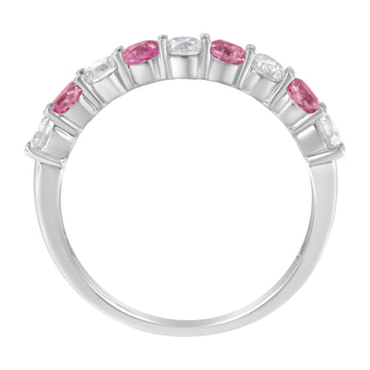 White metal ring with alternating round white gemstones and pink gemstones in prong settings, shown from a front angle.