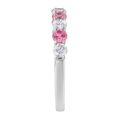 Side view of a white metal ring with alternating round white and pink gemstones in prong settings.