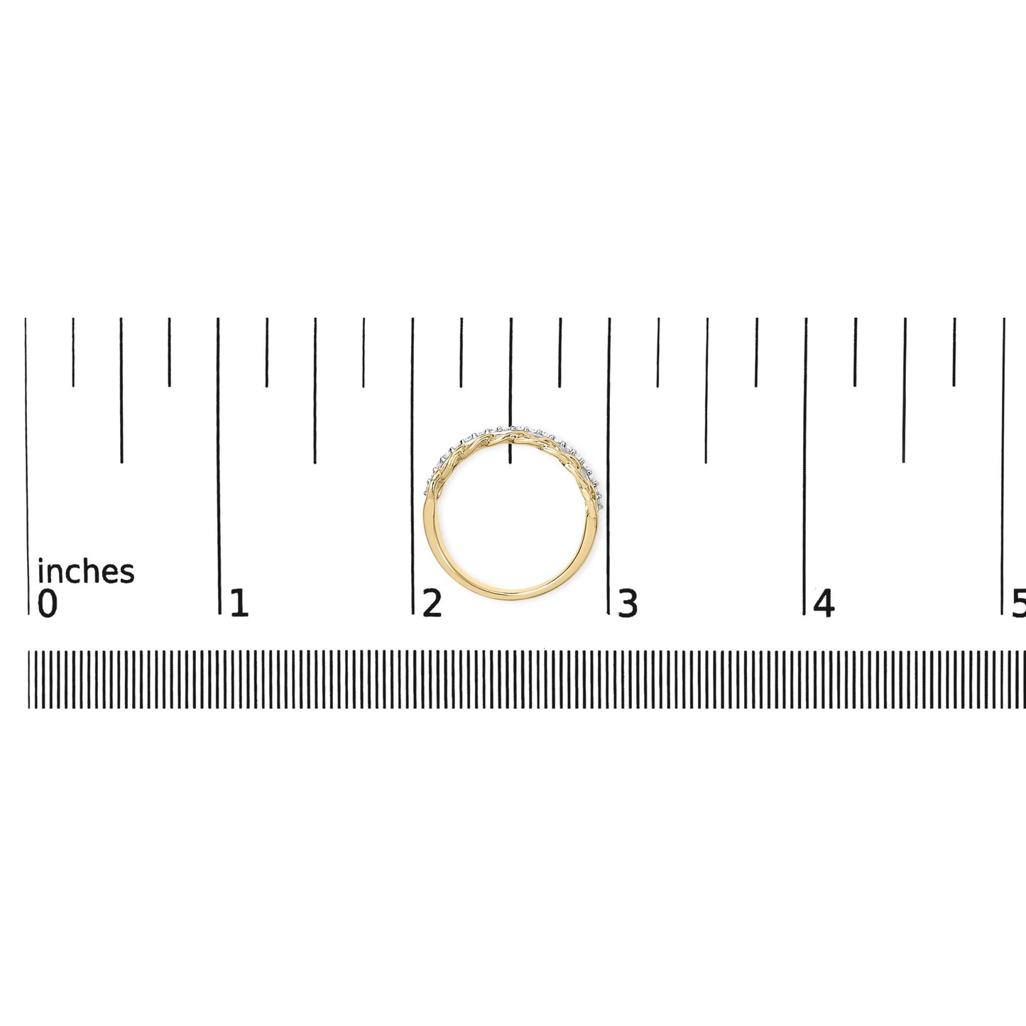Top-down view of a yellow metal ring with a row of round white gemstones in shared prong setting, placed on a ruler for size reference.