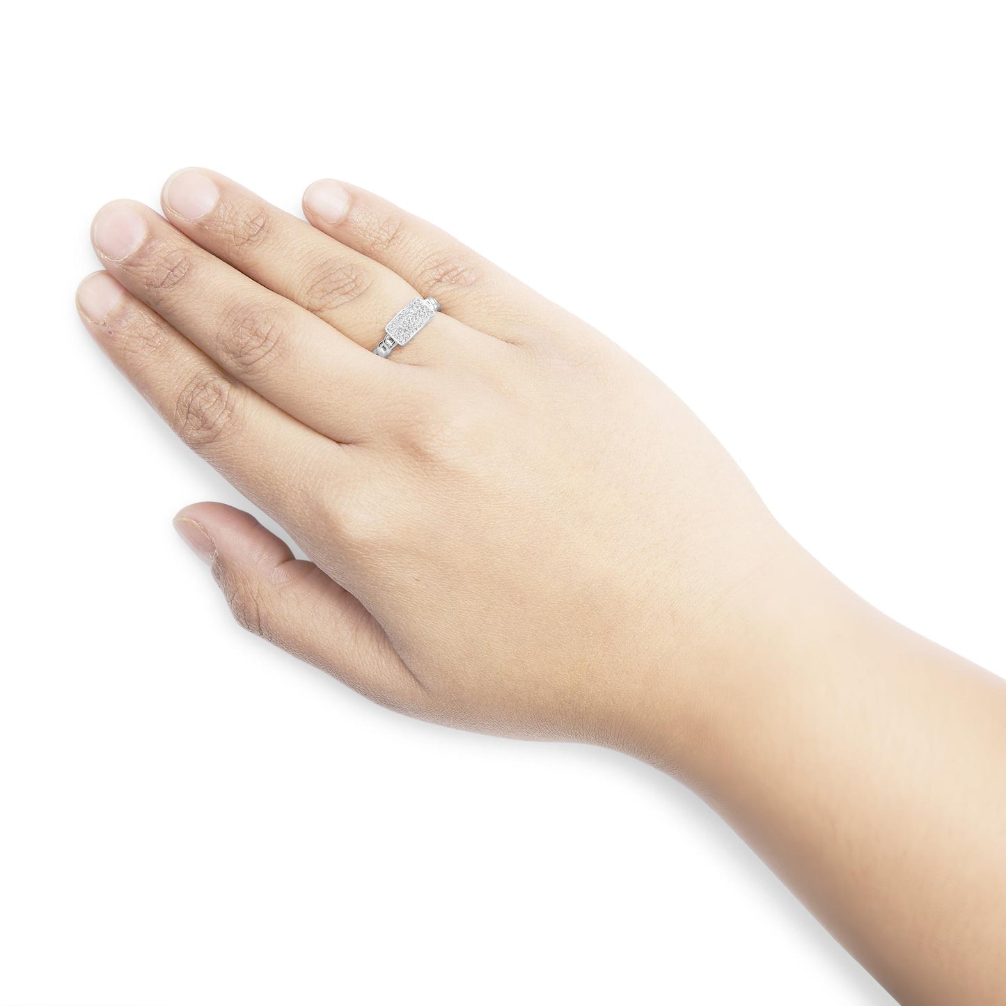 White metal ring with multiple white round gemstones in prong settings on a hand, shown from an angled top view.