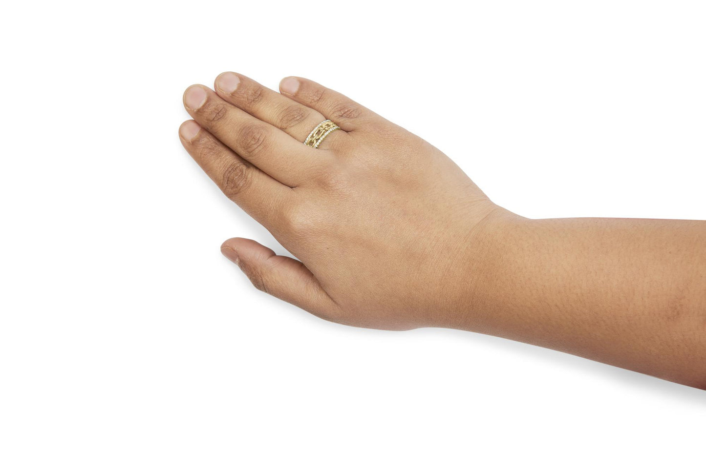 Yellow metal ring with channel-set white round gemstones worn on a model's hand, shot from a top side angle.