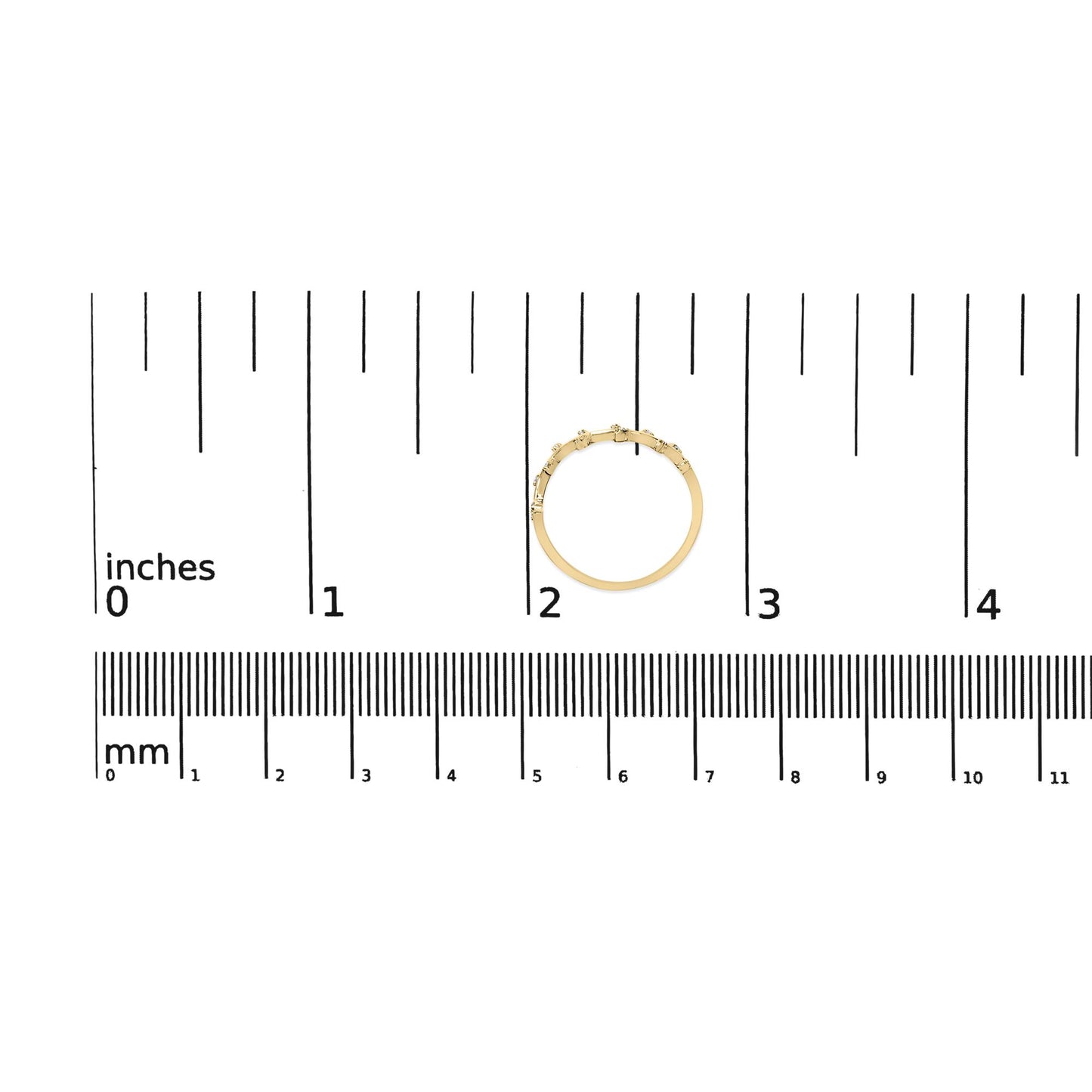 Yellow metal ring with round white gemstones in prong settings, shown from top angle on a ruler for size reference.