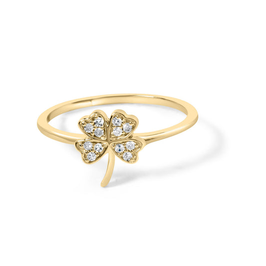 Yellow metal ring with a four-leaf clover design featuring round white gemstones in prong settings, shown in a front angled close-up.