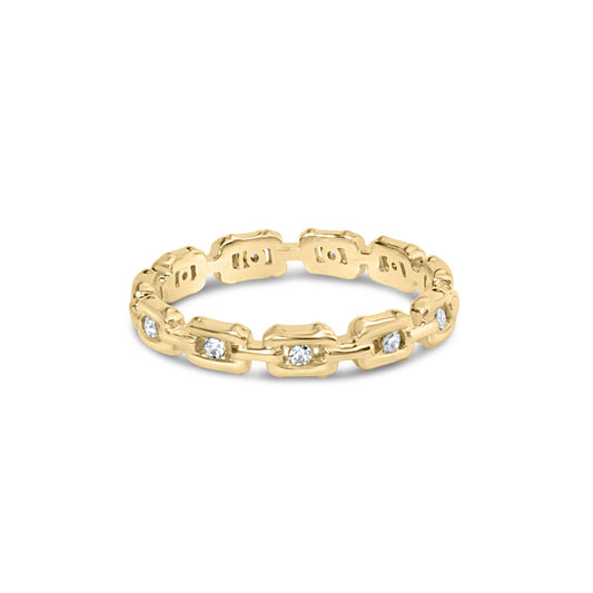Yellow metal ring with round white gemstones in channel setting, shown at a slight angle.