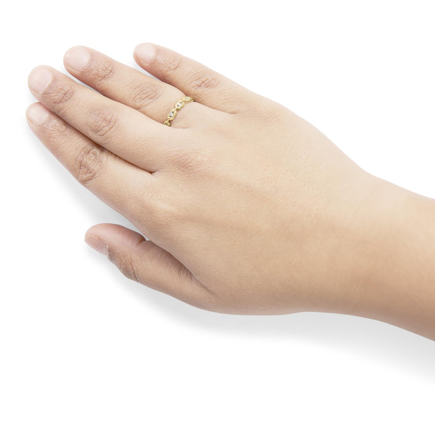 Close-up side angle of a yellow metal ring with white round gemstones in a channel setting, worn on a model's finger.