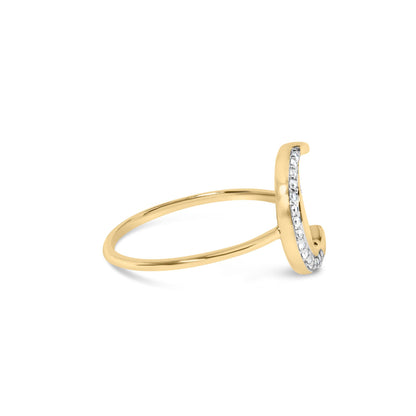 Side angle view of a yellow ring with a curved vertical bar set with round white gemstones in prong settings.