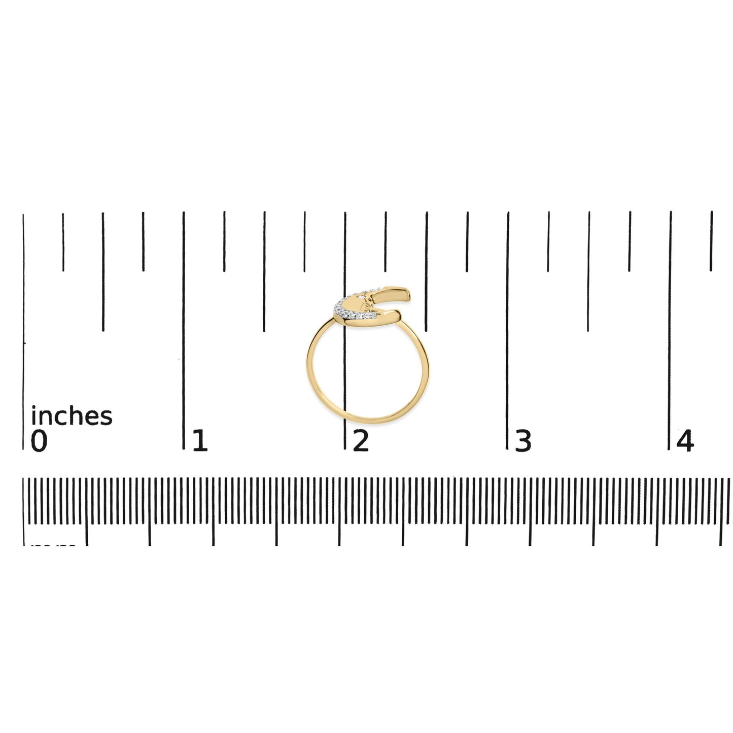 Top-down view of a yellow ring with round white gemstones in prong settings along the open curved band, placed on a ruler for size reference.