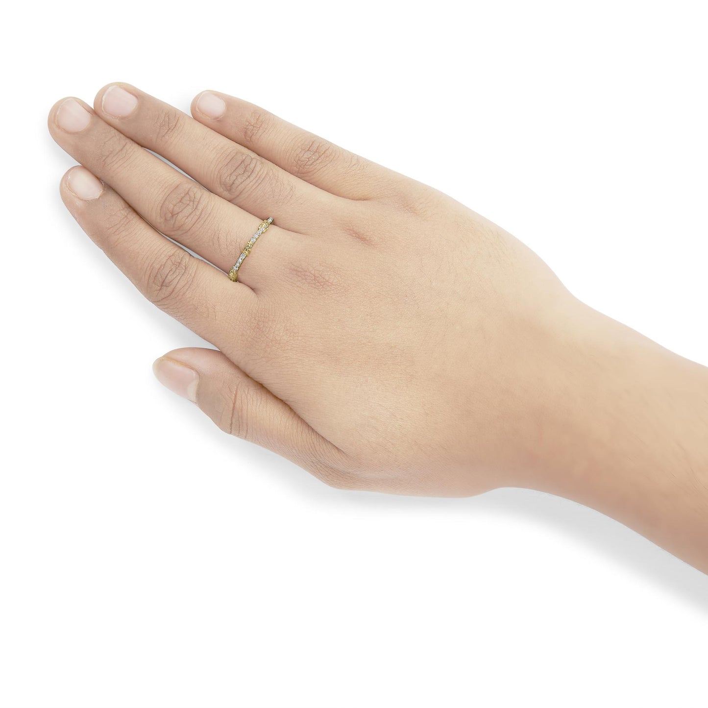 Yellow metal ring with round white gemstones in prong settings, worn on a model's hand shown from a top angle.