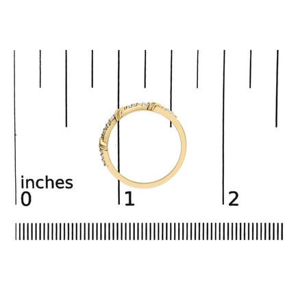 Yellow metal ring with round white gemstones in prong settings, shown flat on a scale from a top-down angle.