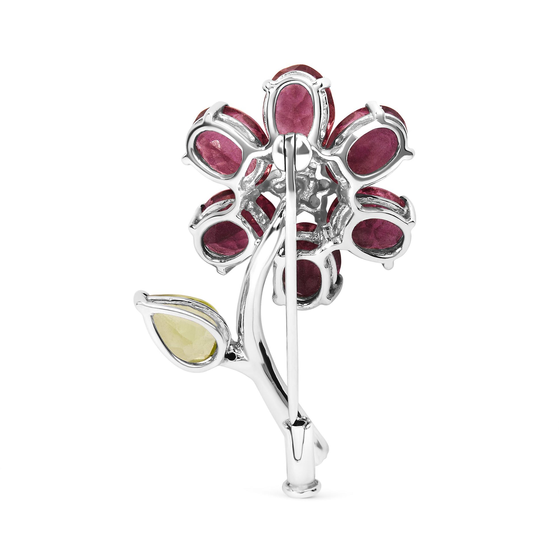 Back view of white metal flower-shaped brooch with pink oval and green pear-shaped gemstones, shown upright.