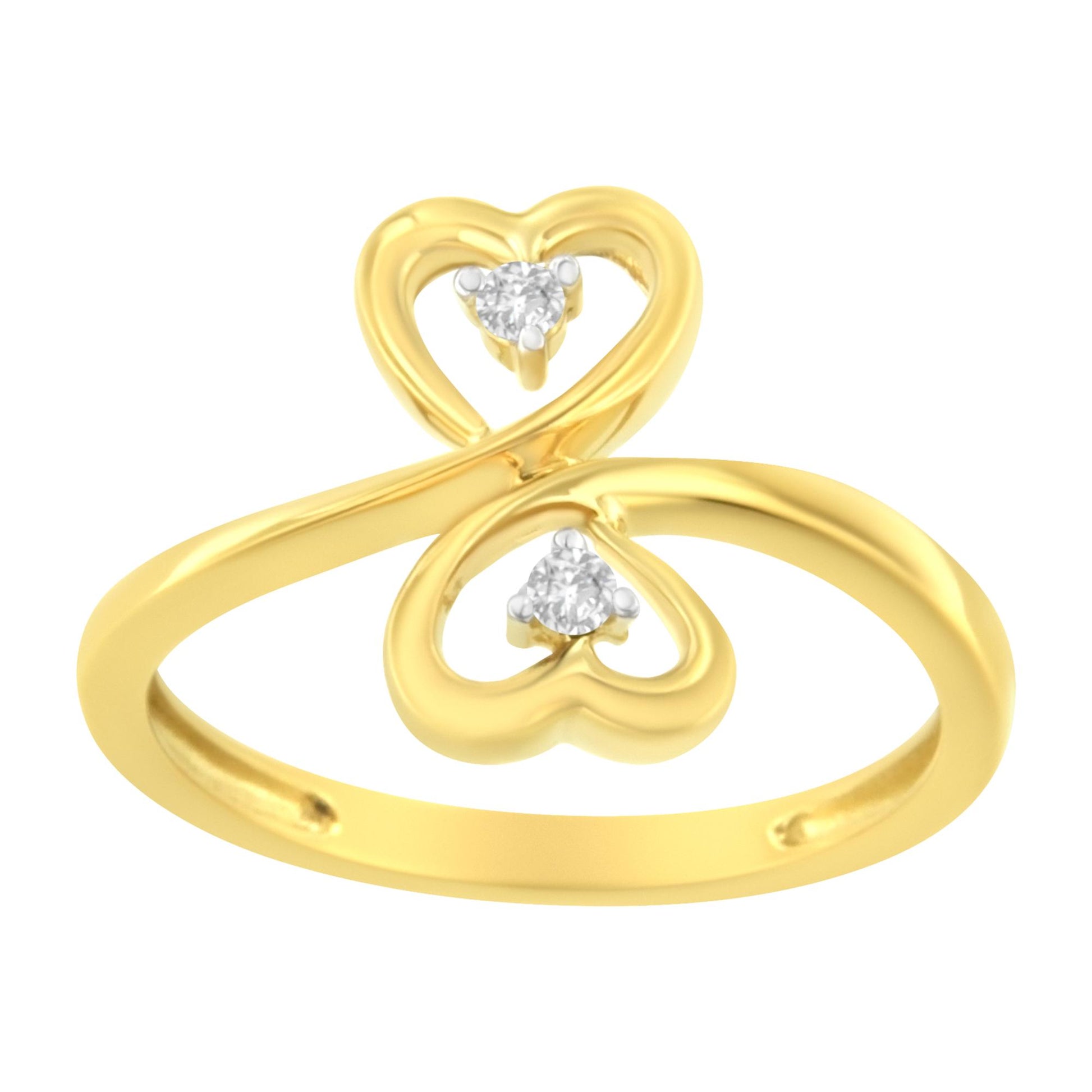 Yellow metal ring with two heart-shaped loops each holding a round prong-set brownish gemstone, shown in a front angled close-up.