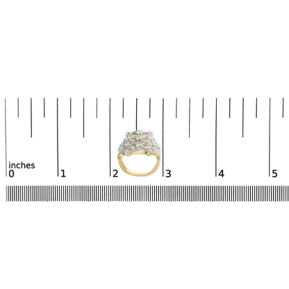Top-down view of a yellow metal ring with multiple rows of white round prong-set gemstones, displayed on a ruler for size reference.