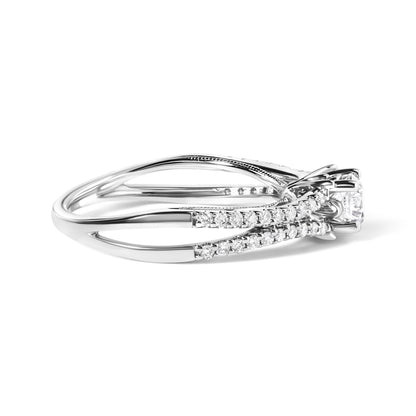 Side angled view of a white metal ring with a single round gemstone in a four-prong setting and multiple smaller round gemstones in a shared prong setting along the band.