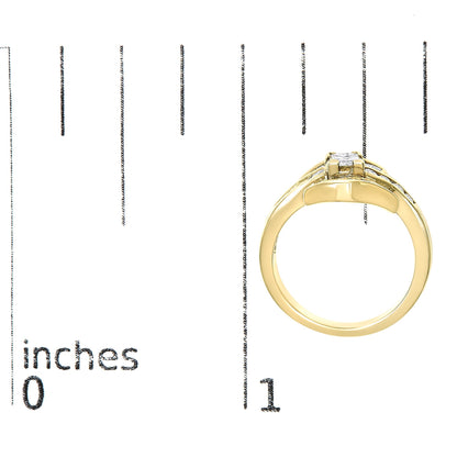Close-up front angle of a yellow metal ring shown on a scale, featuring one princess-shaped white gemstone in a prong setting, accented by multiple baguette-shaped and round-shaped white gemstones in channel settings.