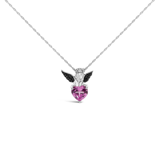 Front view of a white and black metal necklace pendant featuring an angel holding a heart-shaped pink gemstone, with black round gemstones on the wings and white round gemstones as a halo.