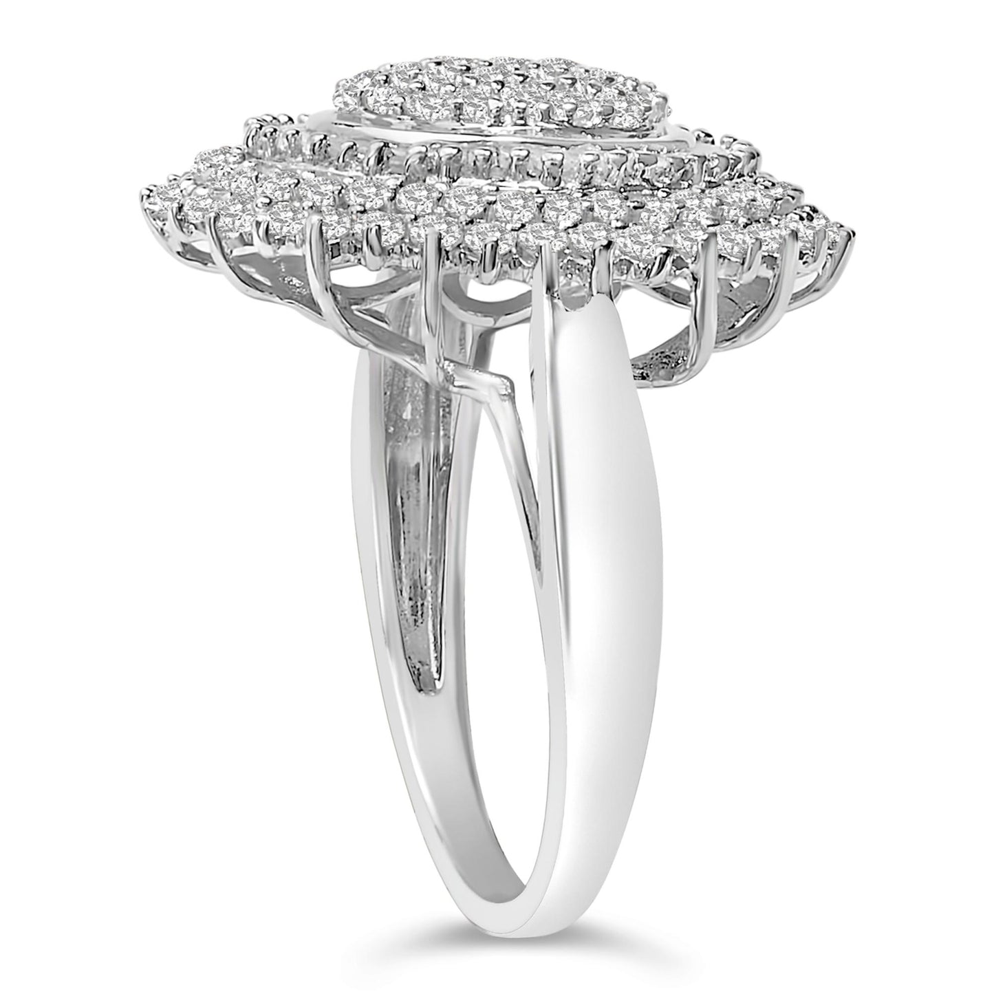 Close-up side angle of a white metal ring featuring a raised oval-shaped top with multiple round white gemstones in prong settings and baguette white gemstones in channel settings.