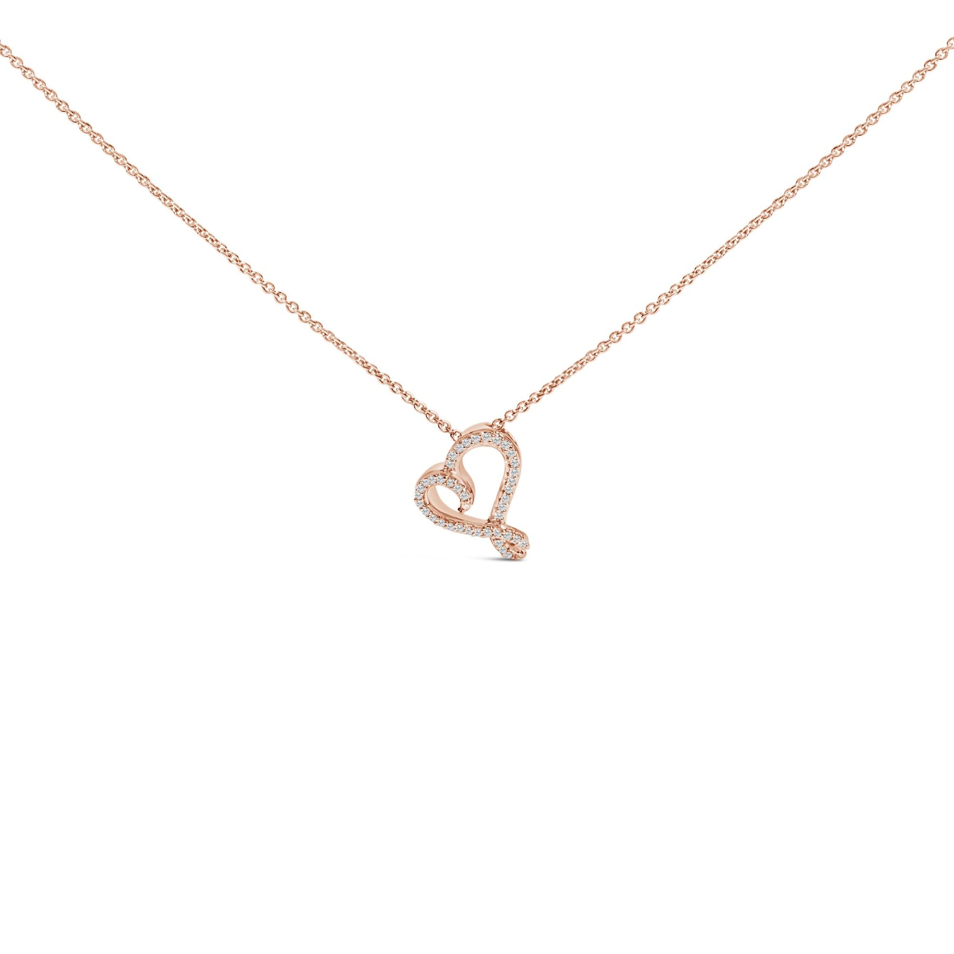 Close-up front view of a rose-colored necklace with a heart-shaped pendant outlined with round white gemstones in bezel settings.