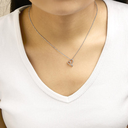 Necklace shown worn on model, featuring a white and rose heart-shaped pendant with round white gemstones in bezel settings, shot from a front-close angle.