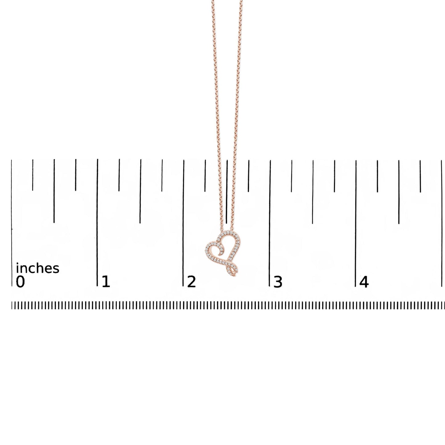 Rose and white metal heart-shaped necklace with round white gemstones in bezel setting, shown hanging against a ruler scale, front view.