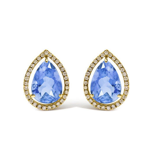 Close-up front angle of yellow metal earrings featuring large pear-shaped blue gemstones surrounded by a halo of small round white gemstones in prong settings.