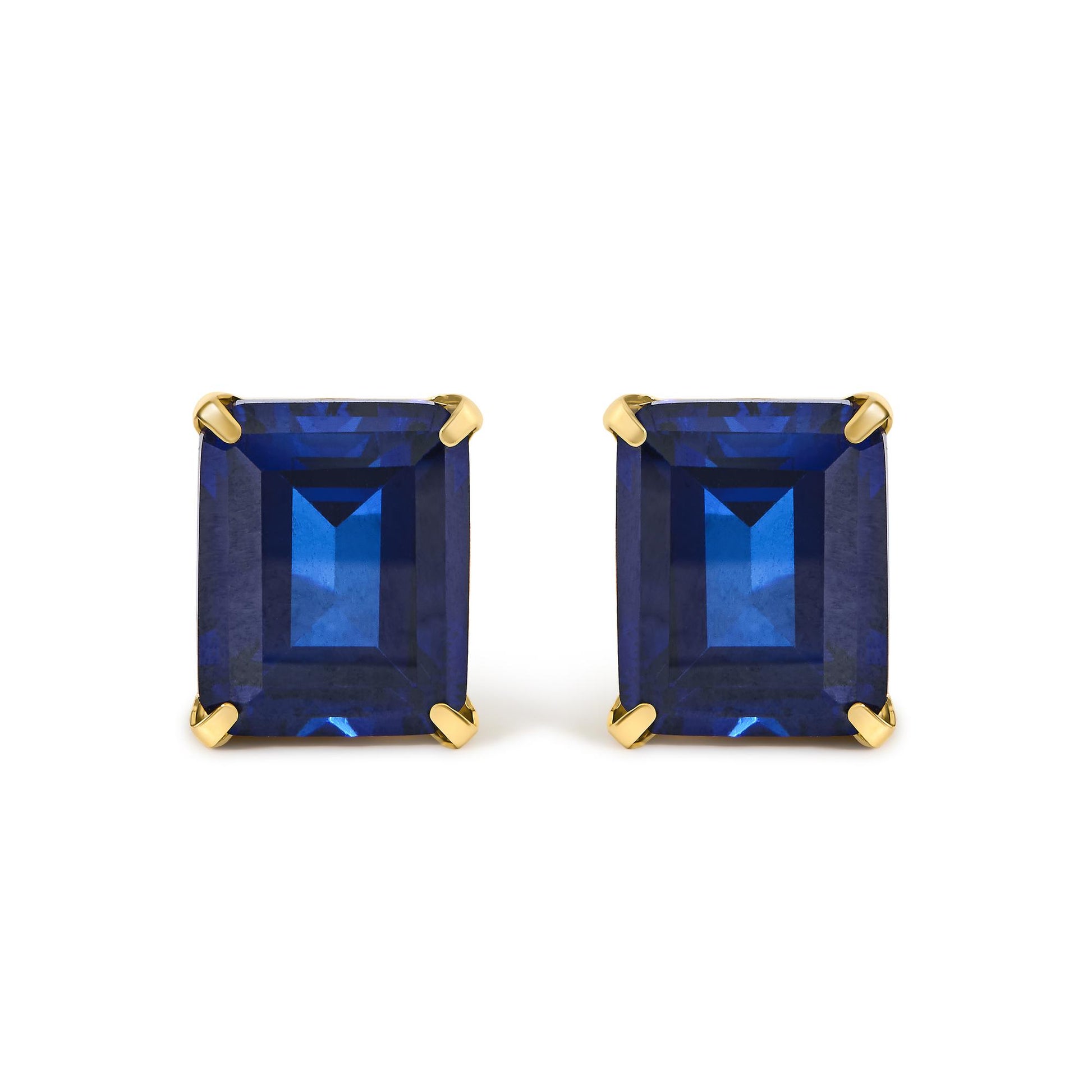 Close-up front view of a pair of yellow metal earrings featuring large rectangular blue gemstones in four-prong settings.