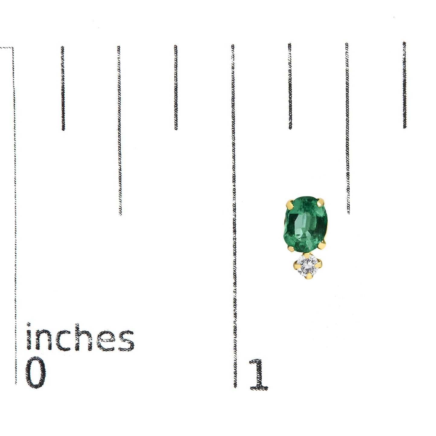 Close-up front angle of a yellow metal earring featuring an oval green gemstone set above a smaller round white gemstone, both in four-prong settings, shown on a measurement scale.