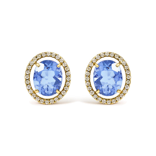 Close-up front view of yellow metal earrings featuring large oval blue gemstones at the center, surrounded by a halo of small round white gemstones in prong settings.