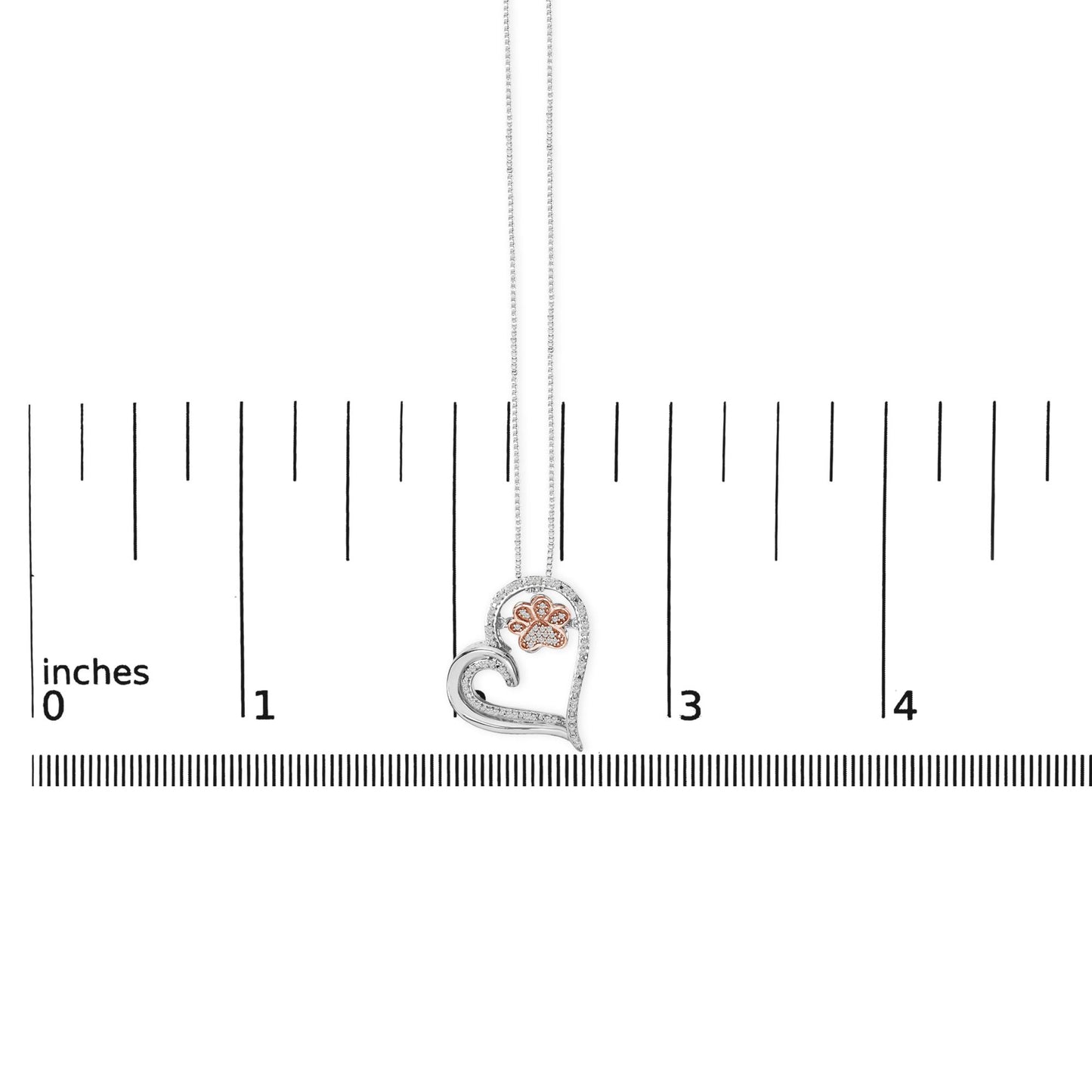 Necklace pendant shown on a scale, featuring a white and rose metal heart shape with a paw print design, accented with round white gemstones, viewed from the front.
